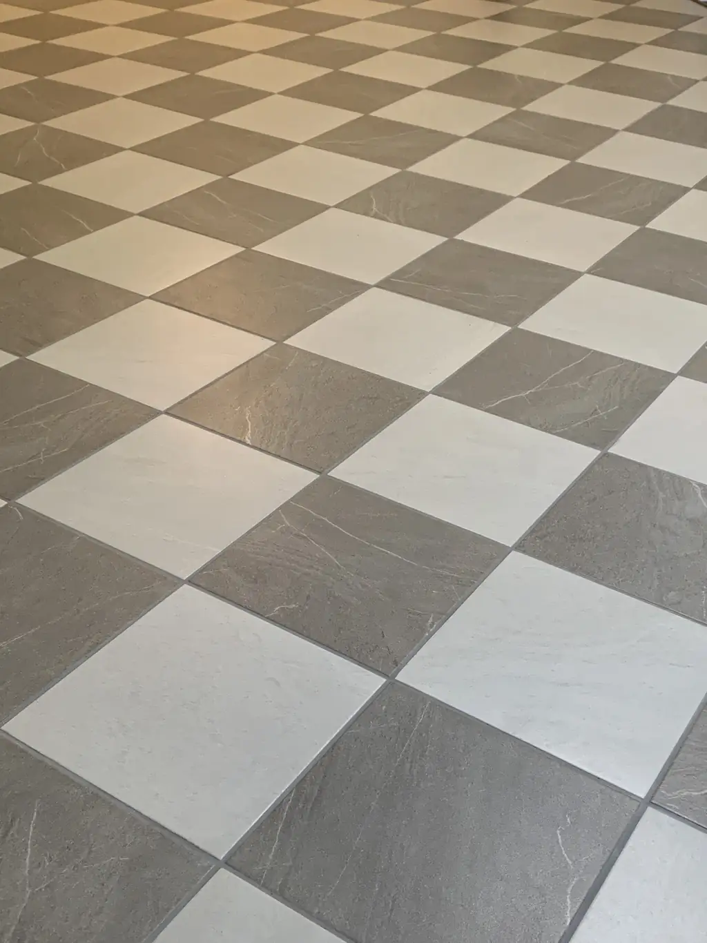 Grey and white checkerboard tile floor laid on the diagonal